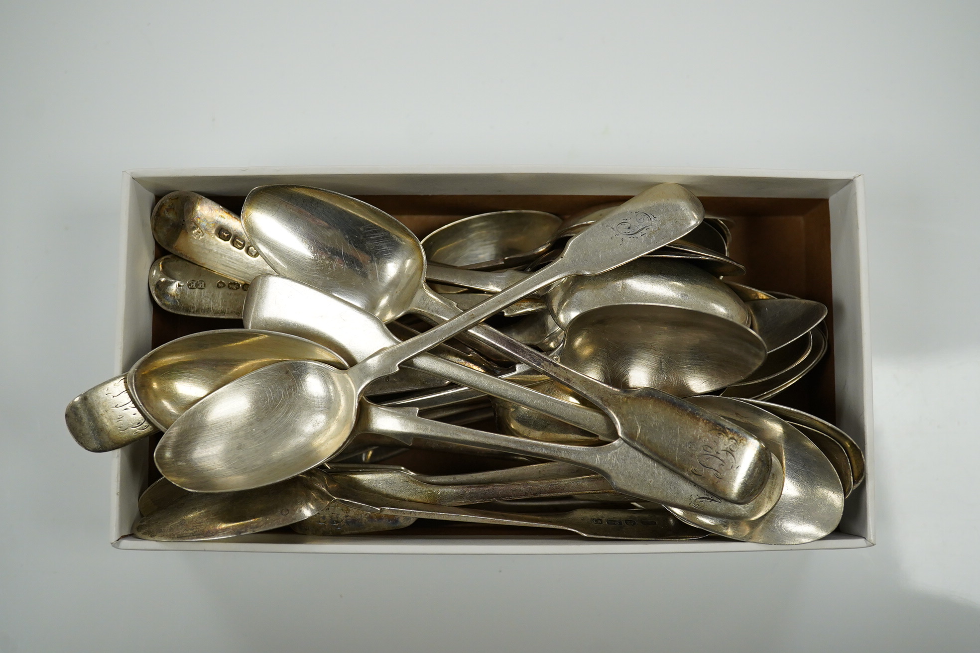 A harlequin set of thirty one William IV and later silver fiddle pattern tea spoons, various dates and makers, 20.9oz. Condition - poor to fair